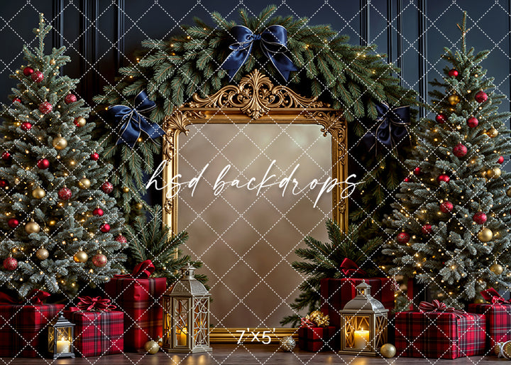 Christmas backdrop with navy bows, gold mirror, red plaid gifts, and holiday trees in a warm evergreen setting.