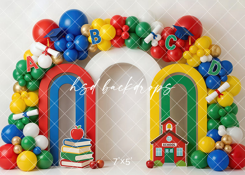 Back to school balloon arch photography backdrop with colorful balloons, alphabet letters, books, apples, diplomas, and a schoolhouse for kids portrait photography.
