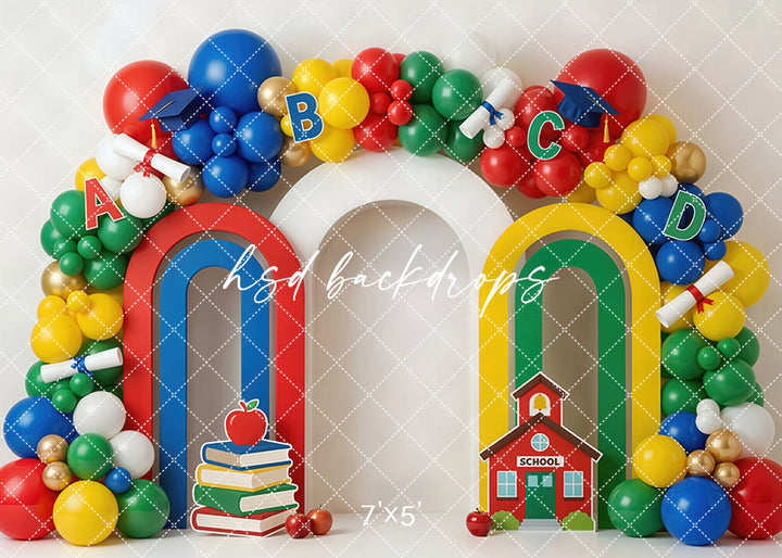 Back to school balloon arch photography backdrop with colorful balloons, alphabet letters, books, apples, diplomas, and a schoolhouse for kids portrait photography.