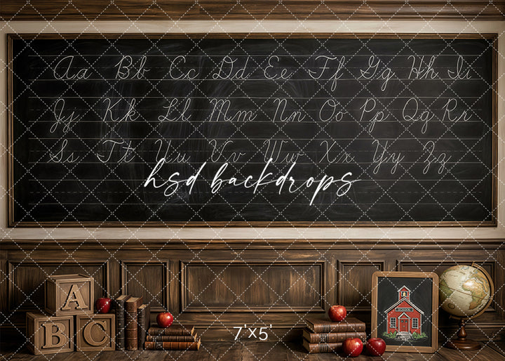 Cursive Alphabet school photography backdrop with a large chalkboard, wood paneling, vintage books, apples, alphabet blocks, a schoolhouse sign, and globe for classroom portraits.