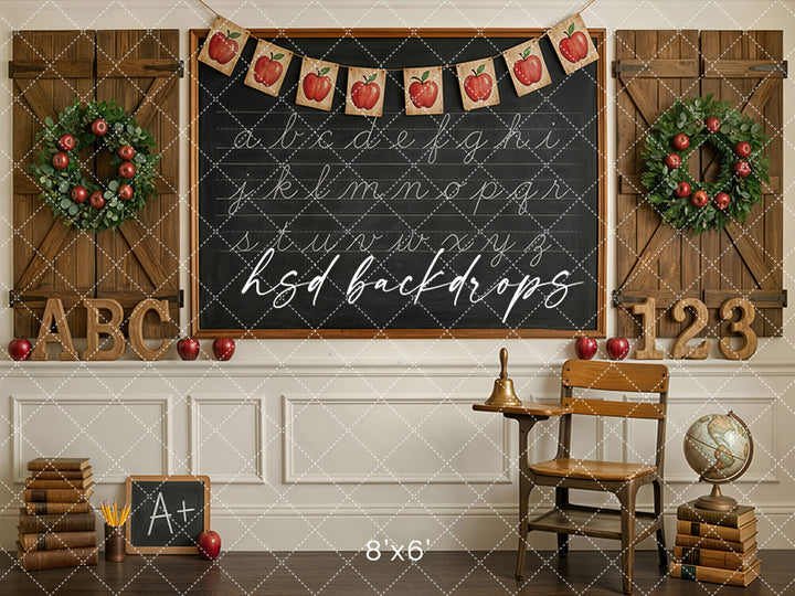 Apple Banner School photography backdrop with chalkboard, wooden shutters, apple wreaths, alphabet and number accents, books, and a vintage classroom chair for school portraits.