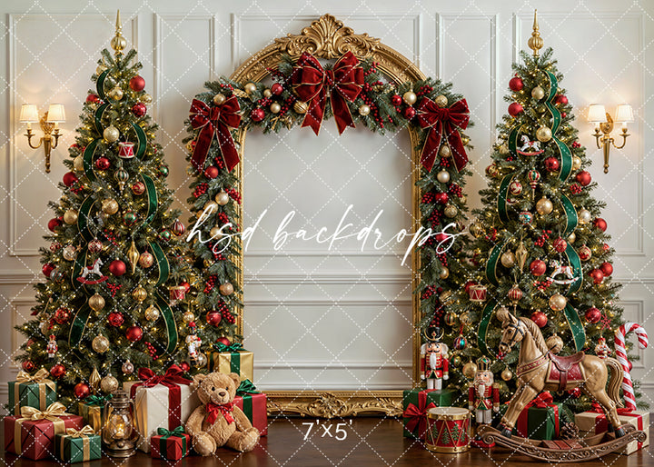 Heirloom Holiday Christmas photography backdrop with an ornate gold arch, decorated Christmas trees, red bows, wrapped gifts, rocking horse, teddy bear, toy drum, and classic holiday décor for portrait photography.