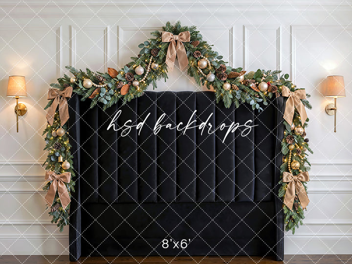 Black Bow Holiday Headboard photography backdrop with a black upholstered headboard, festive garland, champagne ornaments, glowing lights, and elegant Christmas bows for portrait photography.
