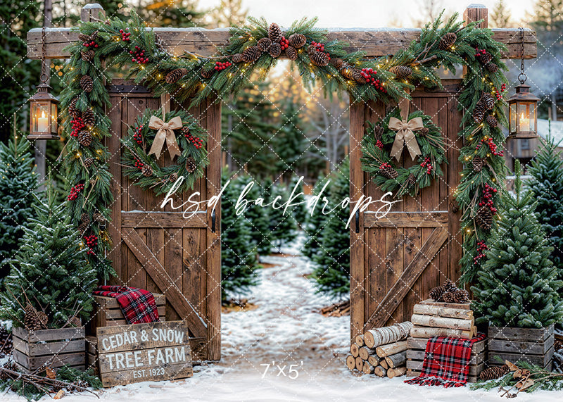 Cedar and Snow Tree Farm photography backdrop with rustic wooden gates, evergreen garland, wreaths, lanterns, plaid accents, snow, and Christmas trees for holiday portrait photography.
