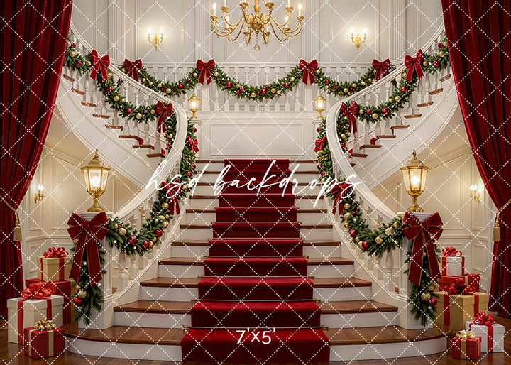 Grand Holiday Staircase photography backdrop with sweeping staircases, red carpet steps, festive garland, ribbon bows, chandeliers, lanterns, and wrapped gifts for holiday portrait photography.