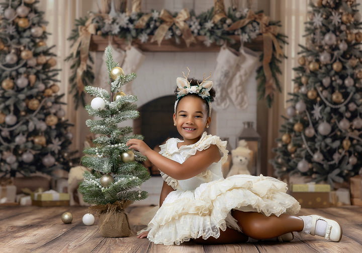 Champagne Christmas fireplace backdrop with neutral holiday décor, flocked trees, ivory mantel, beige bows, stockings, soft gold ornaments, and elegant Christmas portrait styling.