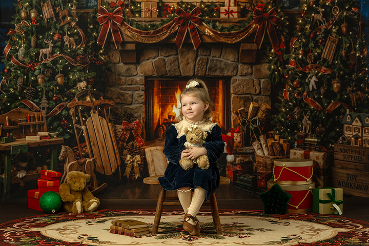 Cozy Santa workshop portrait backdrop with warm fireplace light, festive Christmas trees, wrapped gifts, vintage toys, rocking horse, and classic holiday decorations.