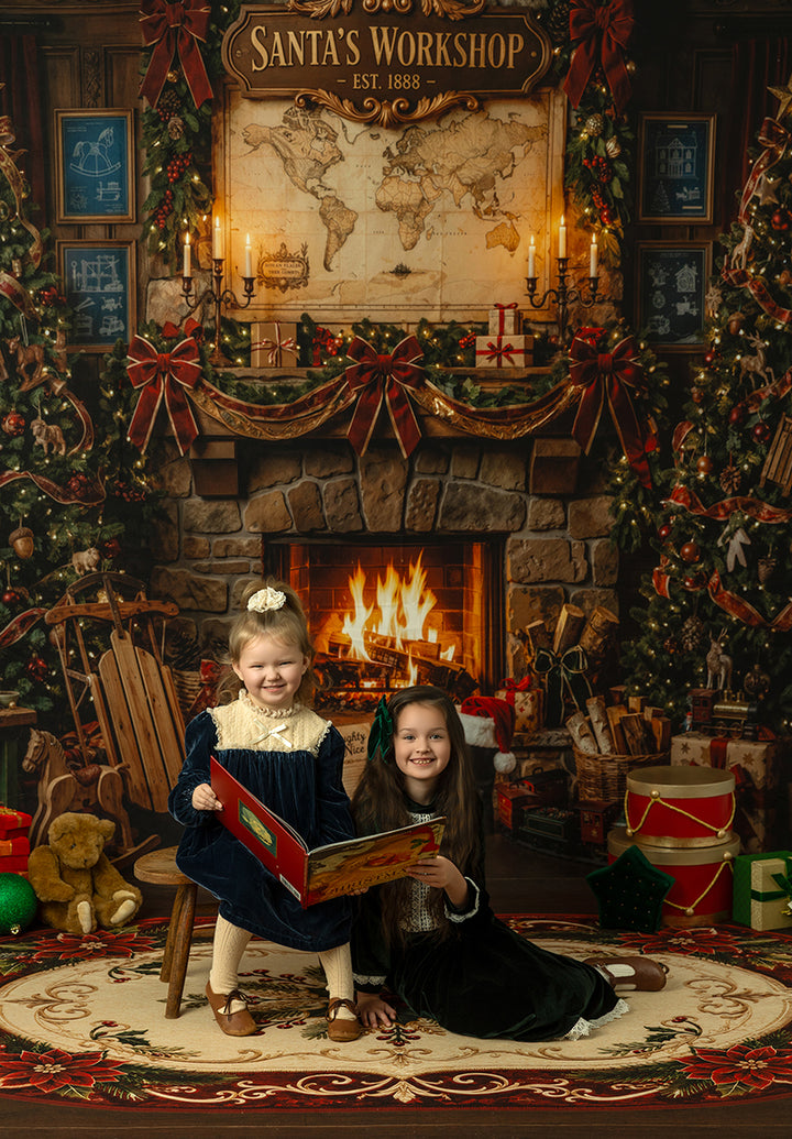 North Pole workshop fireplace backdrop with Santa’s Workshop sign, world map, candlelight, garland, red ribbon bows, toys, and rustic Christmas portrait details.