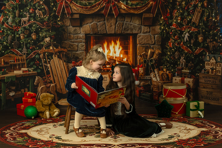 Vintage Santa’s Workshop Christmas backdrop with stone fireplace, holiday greenery, toy-filled shelves, sled, teddy bears, wrapped gifts, and warm festive studio styling.