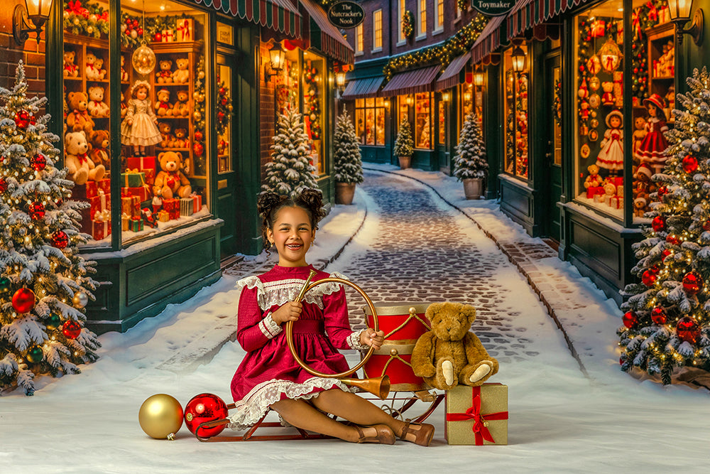 Snowy Christmas toy shop portrait backdrop with festive storefront displays, decorated trees, glowing lights, wrapped presents, teddy bear props, and a magical holiday village scene.