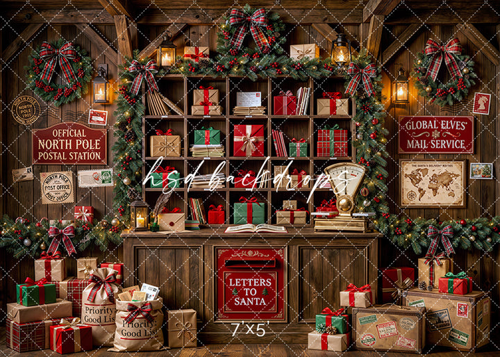 North Pole Post Office photography backdrop with wooden mail shelves, wrapped gifts, plaid wreaths, a letters to Santa mailbox, lanterns, and festive postal station décor for portrait photography.
