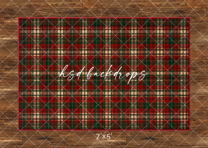 Classic Christmas Plaid photography floor backdrop with a red, green, and cream tartan pattern over a warm wood floor for holiday portrait photography.