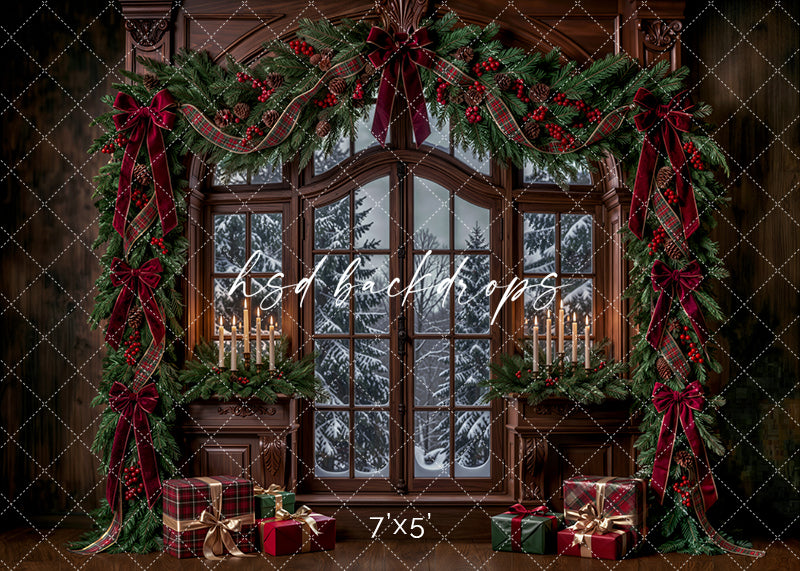 Winter Garland Window Christmas photography backdrop with arched snowy window, rich wood paneling, evergreen garland, burgundy bows, plaid ribbon, candlelight, and wrapped holiday gifts.