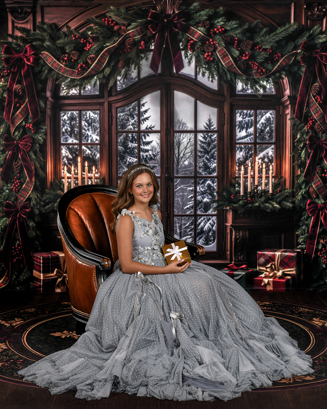 Christmas window garland portrait backdrop with snowy outdoor view, warm wood details, candlelit accents, evergreen holiday greenery, burgundy bows, and elegant winter studio styling.