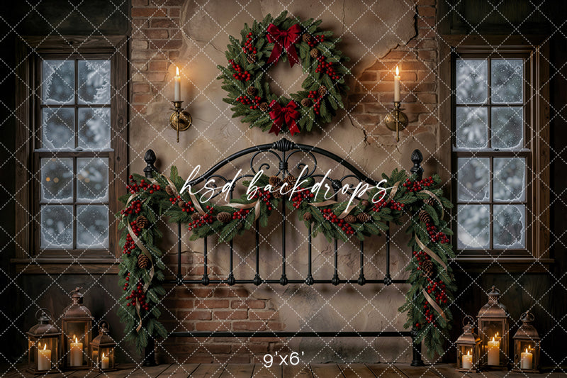 Evergreen Bedframe Christmas photography backdrop with black iron bedframe, rustic brick wall, snowy windows, candle sconces, lanterns, evergreen garland, red berries, pinecones, and festive wreath.