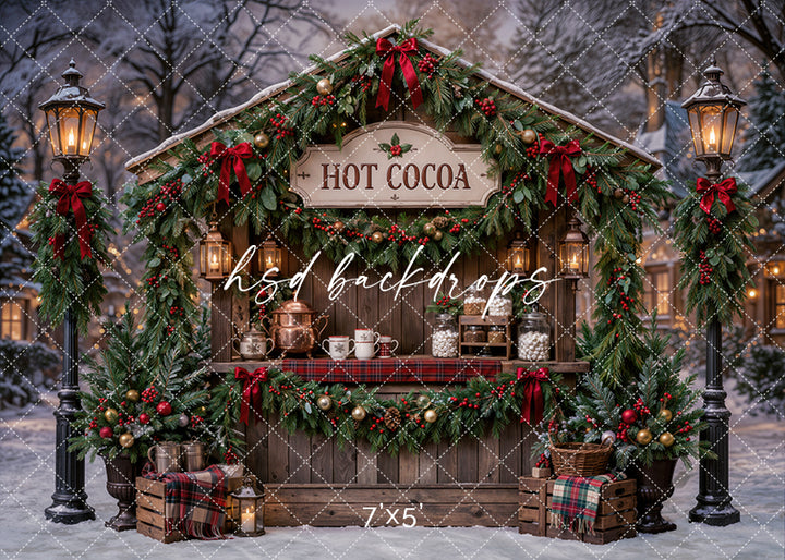 Christmas Hot Cocoa Stand photography backdrop with rustic cocoa booth, evergreen garland, red bows, glowing lanterns, plaid accents, snowy trees, mugs, treat jars, and cozy holiday market styling.