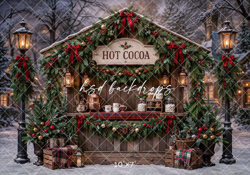 Christmas Hot Cocoa Stand photography backdrop with rustic cocoa booth, evergreen garland, red bows, glowing lanterns, plaid accents, snowy trees, mugs, treat jars, and cozy holiday market styling.