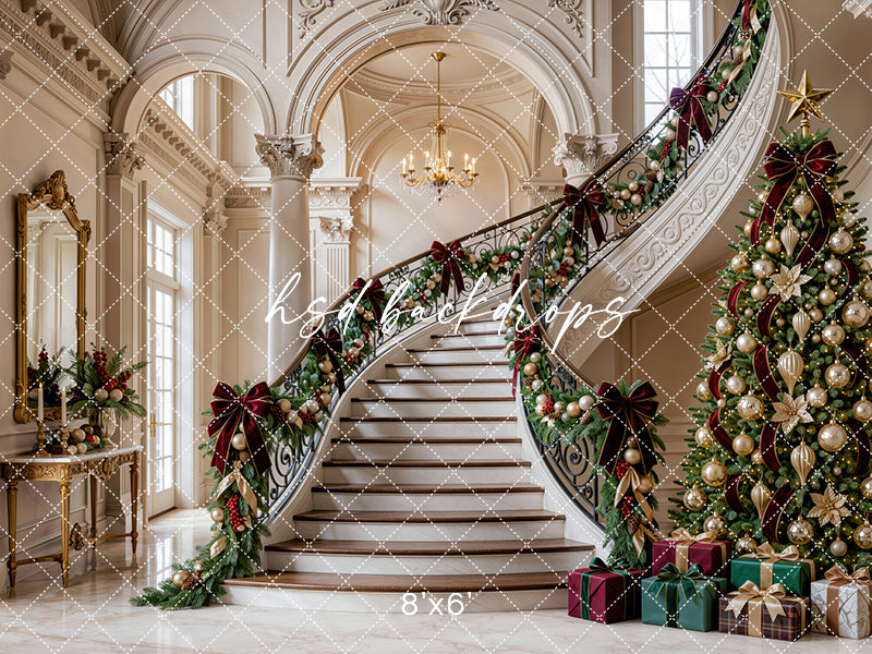 Gilded Christmas Staircase photography backdrop with grand ivory staircase, ornate columns, evergreen garland, burgundy bows, champagne ornaments, decorated Christmas tree, wrapped gifts, and elegant holiday manor styling.