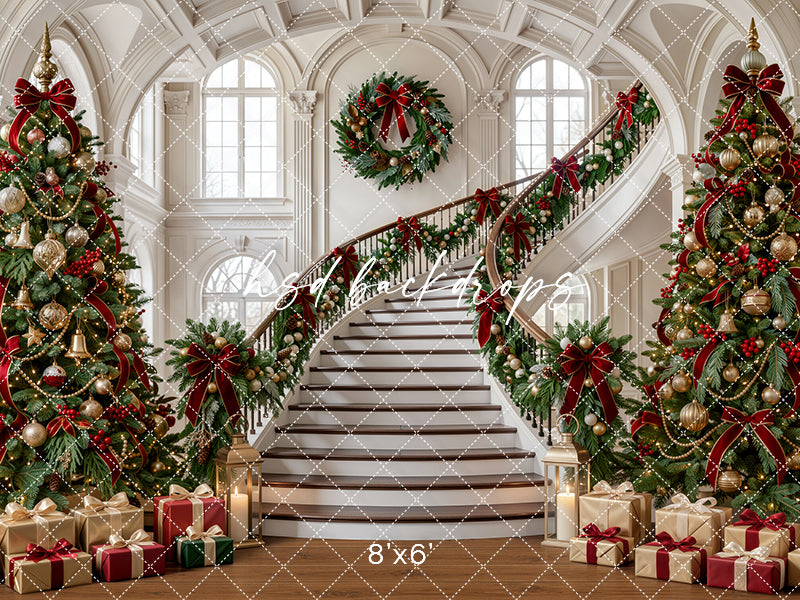 Evergreen Manor Staircase photography backdrop with grand staircase, elegant ivory architecture, evergreen garland, burgundy ribbons, champagne ornaments, wrapped gifts, glowing holiday lights, and classic Christmas studio styling.