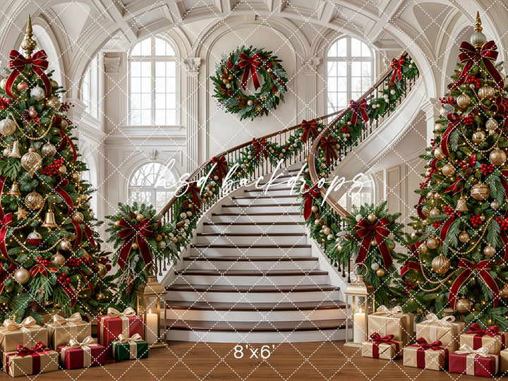Evergreen Manor Staircase photography backdrop with grand staircase, elegant ivory architecture, evergreen garland, burgundy ribbons, champagne ornaments, wrapped gifts, glowing holiday lights, and classic Christmas studio styling.