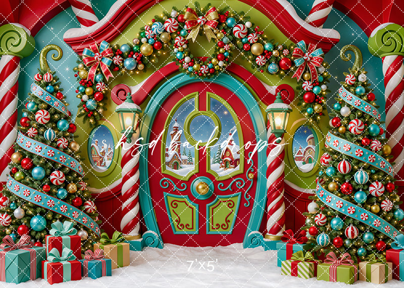 Merryville Christmas Door photography backdrop with colorful red and teal holiday door, peppermint columns, decorated Christmas trees, festive wreath, wrapped gifts, snowy floor styling, and whimsical candy-inspired Christmas décor.
