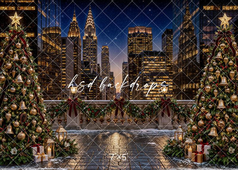 New York Christmas Terrace photography backdrop with sparkling city skyline, decorated Christmas trees, snowy rooftop terrace, evergreen garland, burgundy bows, gold ornaments, lanterns, wrapped gifts, and elegant holiday city styling.