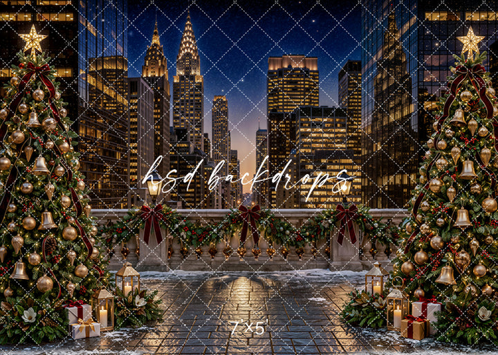 New York Christmas Terrace photography backdrop with sparkling city skyline, decorated Christmas trees, snowy rooftop terrace, evergreen garland, burgundy bows, gold ornaments, lanterns, wrapped gifts, and elegant holiday city styling.