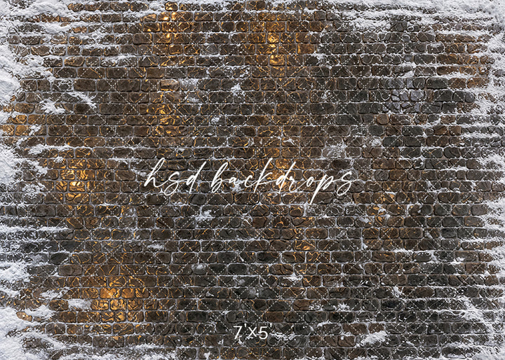 Snowy Cobblestone Glow photography floor backdrop with dark cobblestone texture, snow-covered edges, frosted stone details, warm golden reflections, and winter holiday studio floor styling.