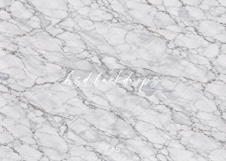 Classic Marble Photography Backdrop featuring a soft white marble stone texture with light gray veining for product photography, branding photos, flat lays, and elegant studio portraits.
