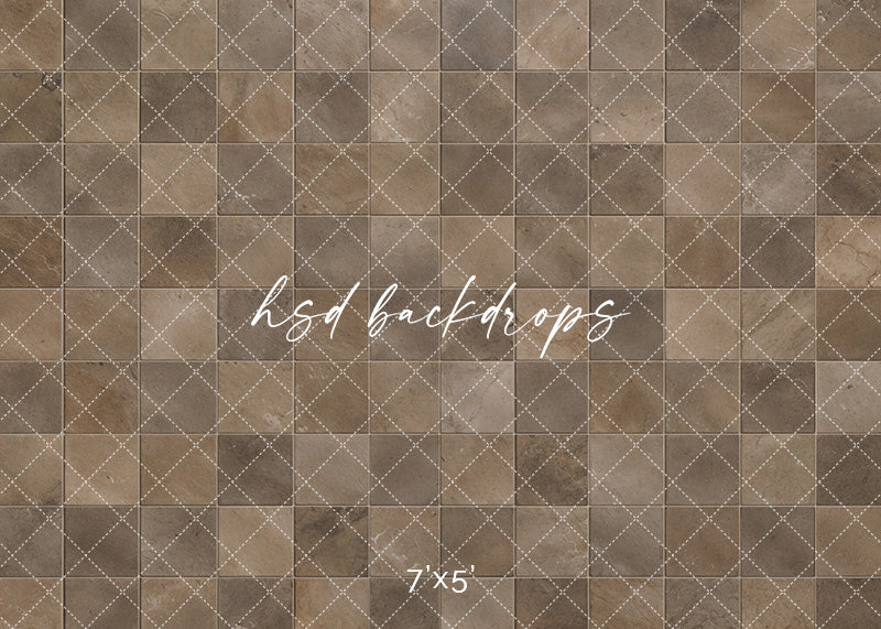 Aged Brown Stone Tile rubber-backed photography floor mat featuring realistic square stone tiles in warm brown, earthy taupe, natural beige, and muted gray with subtle veining, weathered textures, and softly defined grout lines for rustic studio portraits.