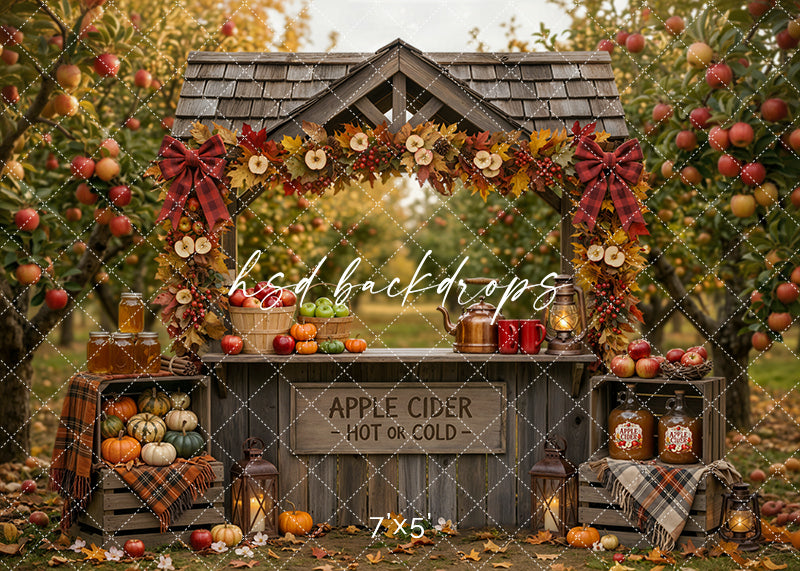 Autumn Apple Cider Stand photography backdrop with rustic cider market stand, apple orchard trees, plaid bows, fall garland, pumpkins, baskets of apples, lanterns, crates, and warm harvest styling.