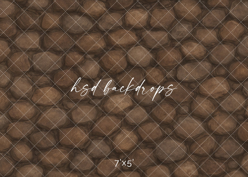 Weathered River Rock photography backdrop featuring layered rounded brown stones with organic tonal variation and rustic natural texture.