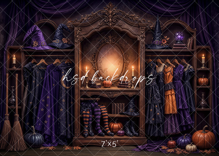 Midnight Witch Boutique photography backdrop with purple and black witch gowns, pointed hats, striped stockings, broomsticks, pumpkins, glowing candles, and an ornate dressing mirror.