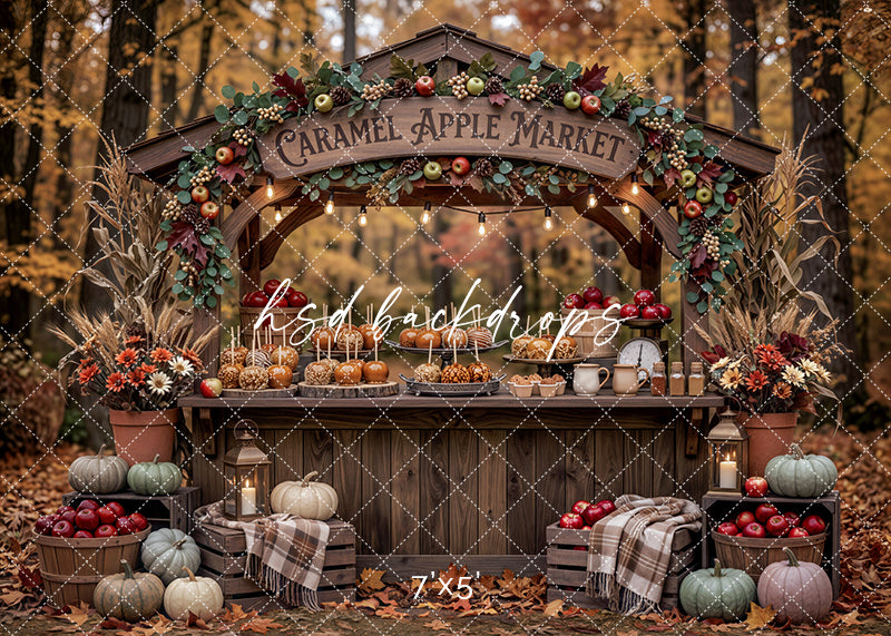 Autumn Caramel Apple Stand photography backdrop with rustic wood market booth, caramel apples, apple garland, pumpkins, lanterns, fall florals, corn stalks, crates, and cozy harvest orchard styling.