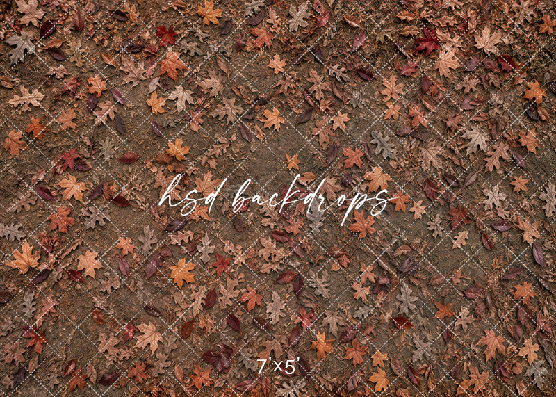 Autumn Leaf Scatter floor mat with rustic earthy ground texture, scattered oak leaves, warm brown tones, rust-colored fall leaves, and natural autumn studio floor styling.
