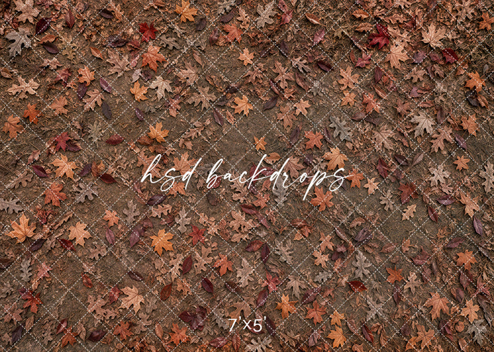 Autumn Leaf Scatter photography floor backdrop with rustic earthy ground texture, scattered oak leaves, warm brown tones, rust-colored fall leaves, and natural autumn studio floor styling.