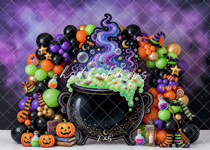 Witch’s Brew Cauldron Halloween photography backdrop with bubbling black cauldron, colorful magical potion, purple smoke, bright balloon garland, pumpkins, potion bottles, witch hats, candy details, and glowing lantern.