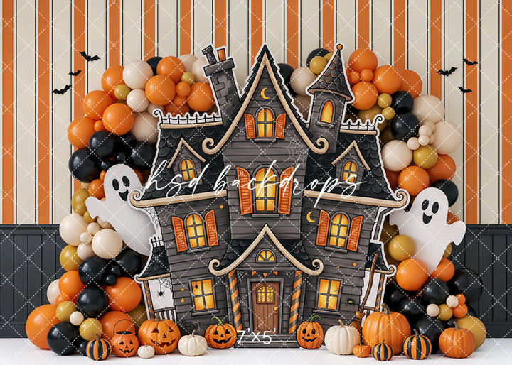 Pumpkin Ghost Manor Halloween photography backdrop with whimsical haunted house, friendly ghosts, orange and black balloon garlands, glowing windows, jack-o’-lanterns, bats, striped details, and playful studio styling.