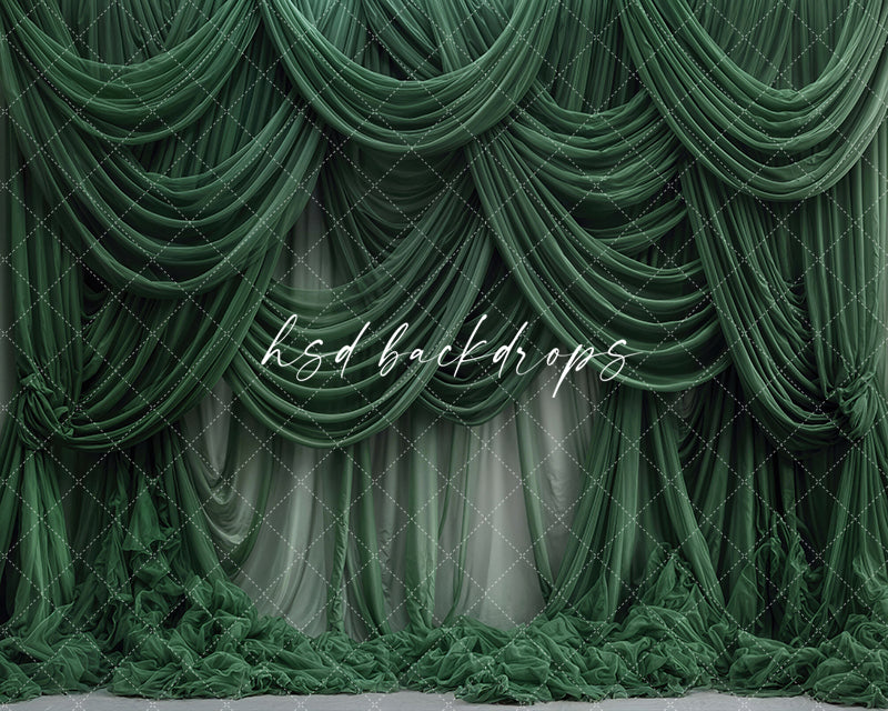 Emerald green draped fabric photography backdrop with cascading curtains.