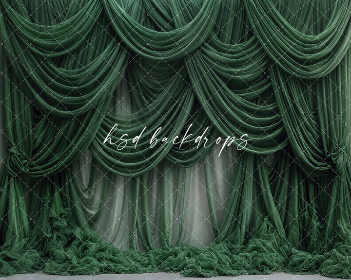 Emerald green draped fabric photography backdrop with cascading curtains.