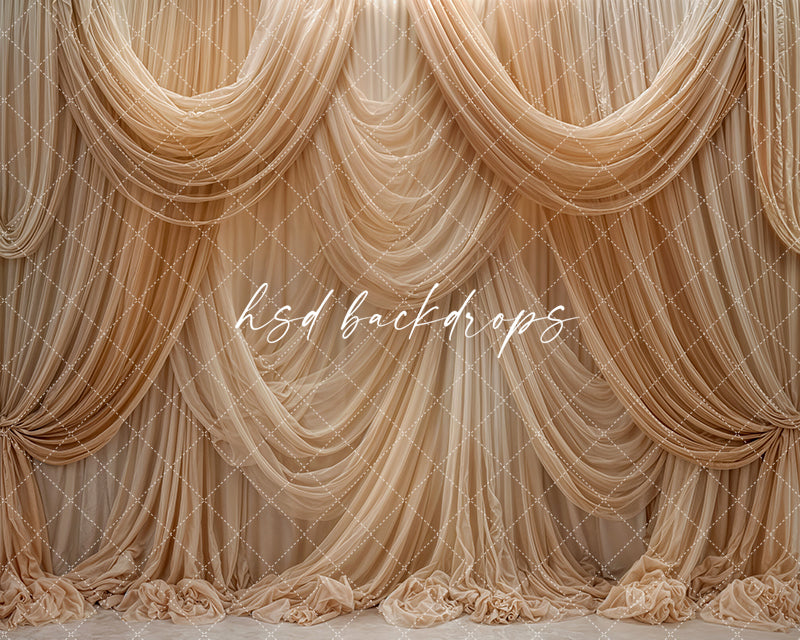 Beige champagne draped fabric photography backdrop with elegant cascading curtains.