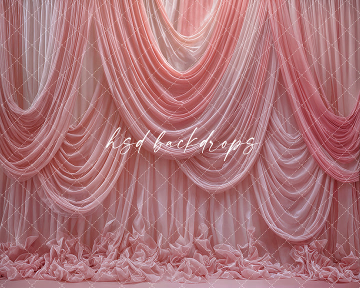Pink draped fabric photography backdrop with elegant cascading curtains.