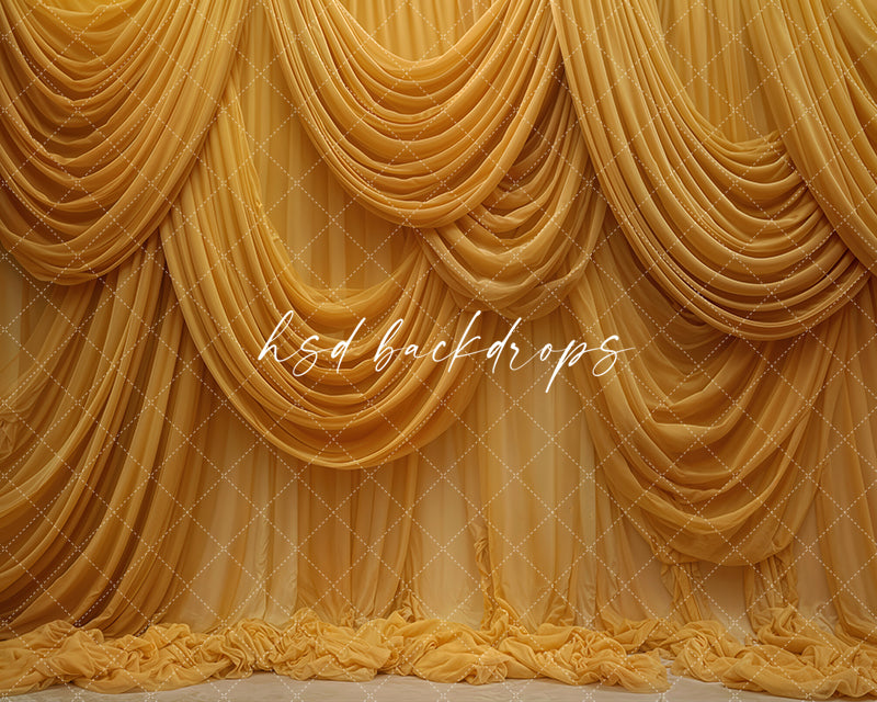Mustard yellow draped fabric photography backdrop with elegant layered curtains.