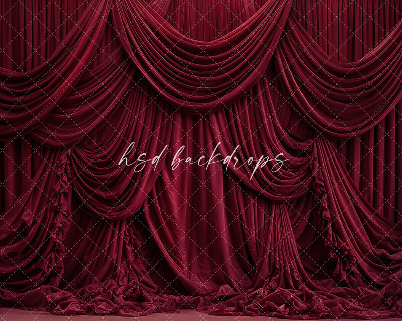 Red draped fabric photography backdrop with elegant cascading curtains.