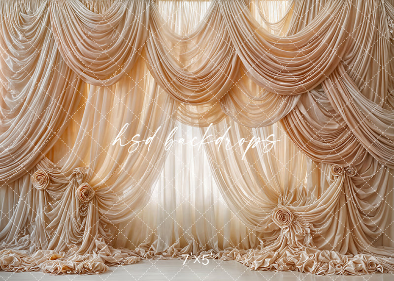 Champagne draped photography backdrop with layered silk folds, large fabric rosettes, and luxurious couture-inspired detailing for elegant portrait sessions.