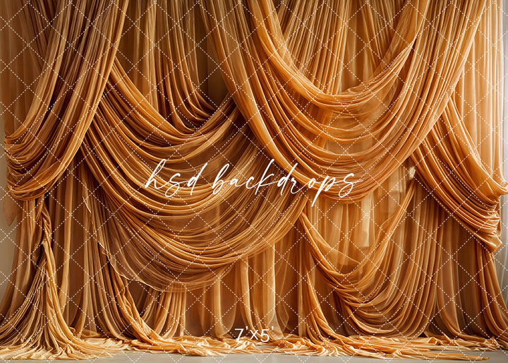 Honey gold draped fabric backdrop with cascading silk folds and couture styling, creating a warm, elegant setting for studio portraits and fine art photography.