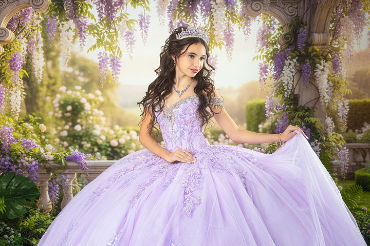 Royal wisteria palace garden quinceañera backdrop featuring elegant stone architecture, cascading lavender flowers, lush botanical greenery, and a quinceañera wearing a sparkling lavender ball gown and tiara.