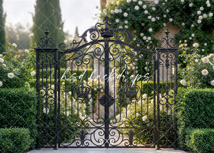 Elegant floral photography backdrop with ornate wrought-iron garden gates, white roses, and manicured greenery for portrait sessions.