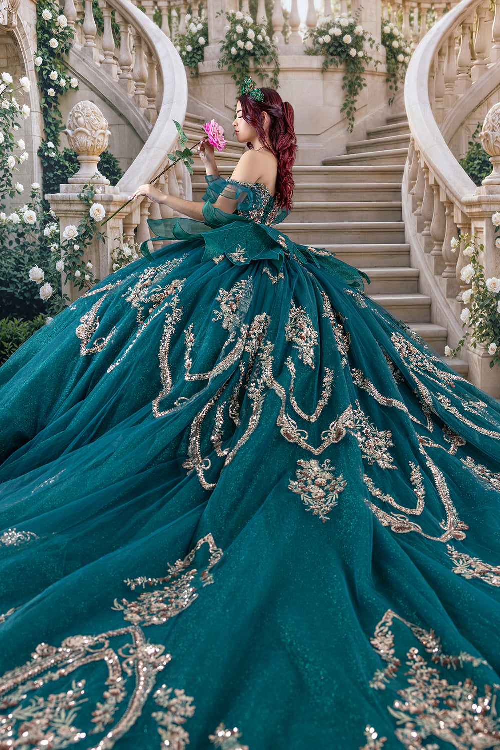 Elegant white rose quinceañera photography backdrop featuring a romantic castle staircase, climbing ivory roses, lush greenery, and a luxurious emerald green embroidered ball gown.