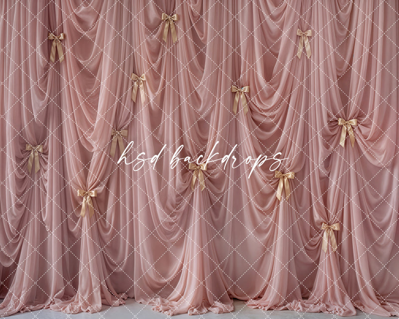 Blush couture bow drapes photography backdrop with cascading blush fabric and gold satin bows for luxury studio portraits by HSD Backdrops